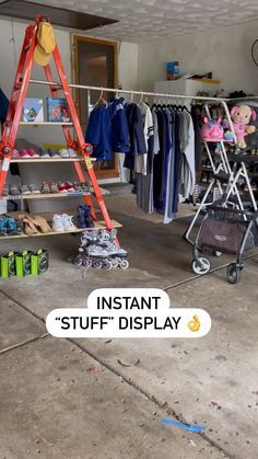 the inside of a clothing store with clothes on racks and ladders in front of it