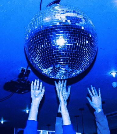 two people reaching up for a disco ball