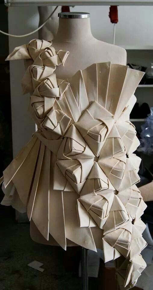 a dress made out of folded paper on a mannequin