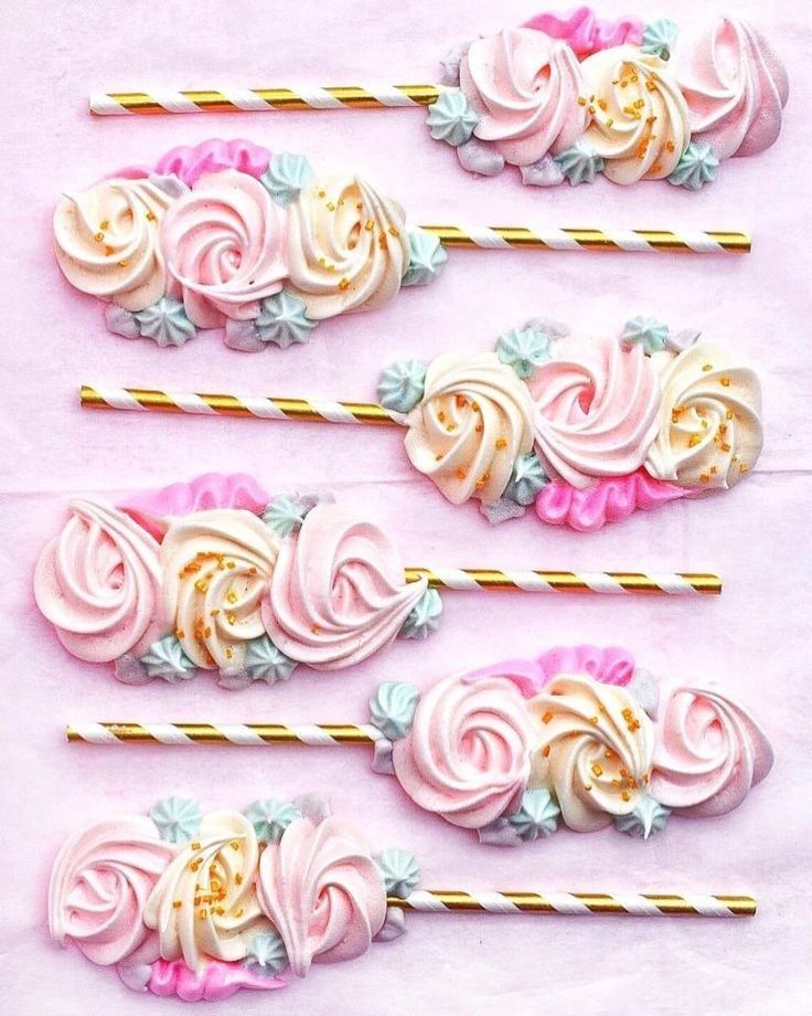 four pink and gold hair pins with flowers on them