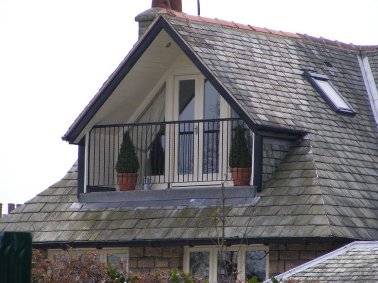 a large house with two windows and a balcony