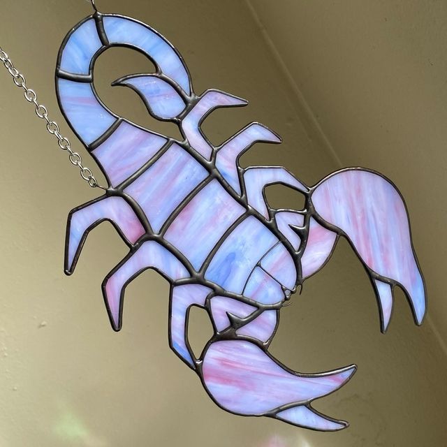 a stained glass crab hanging from the ceiling