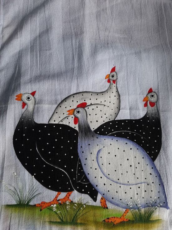 three chickens are standing in the grass on a white linen material with black and red dots