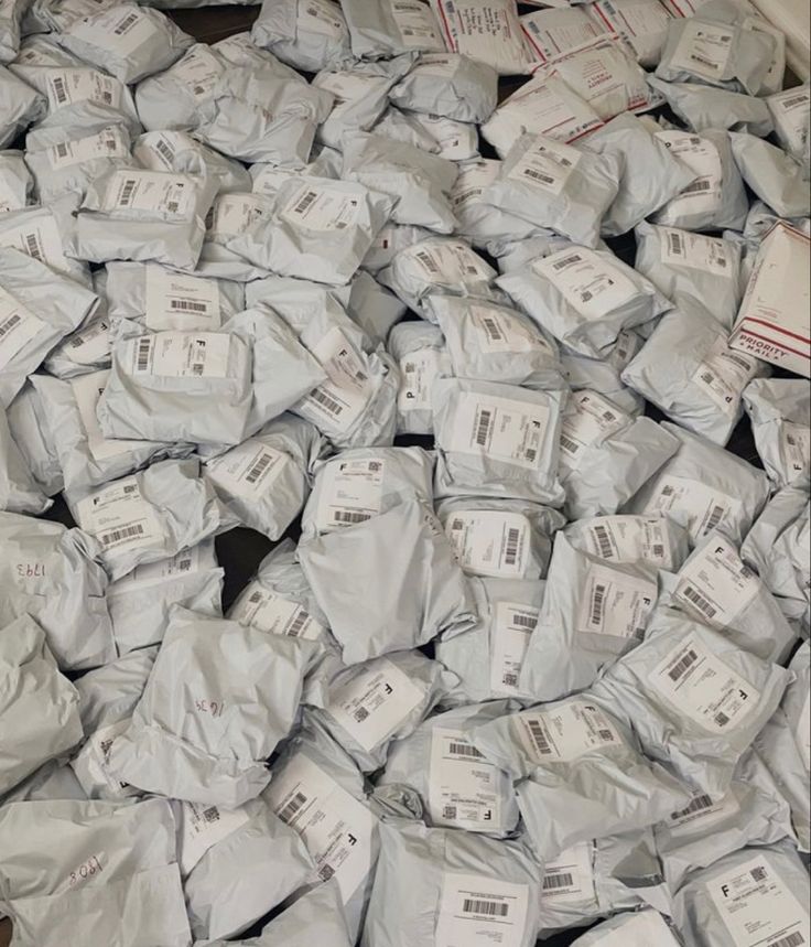 a pile of white bags sitting on top of a wooden floor