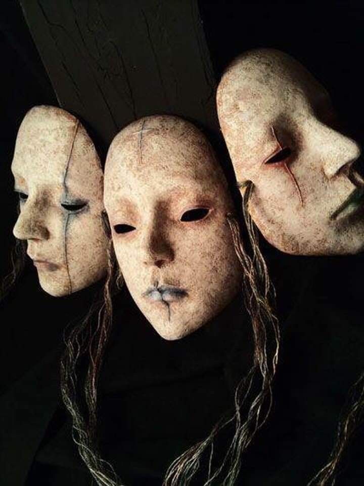 three creepy looking masks with long hair on their heads and eyes are shown in front of a black background