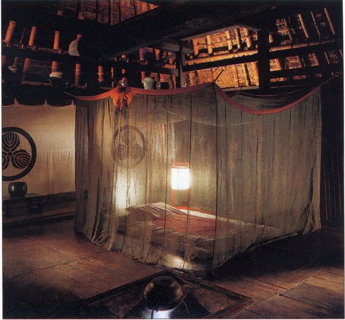 a bedroom with a canopy bed and lots of books on the shelves