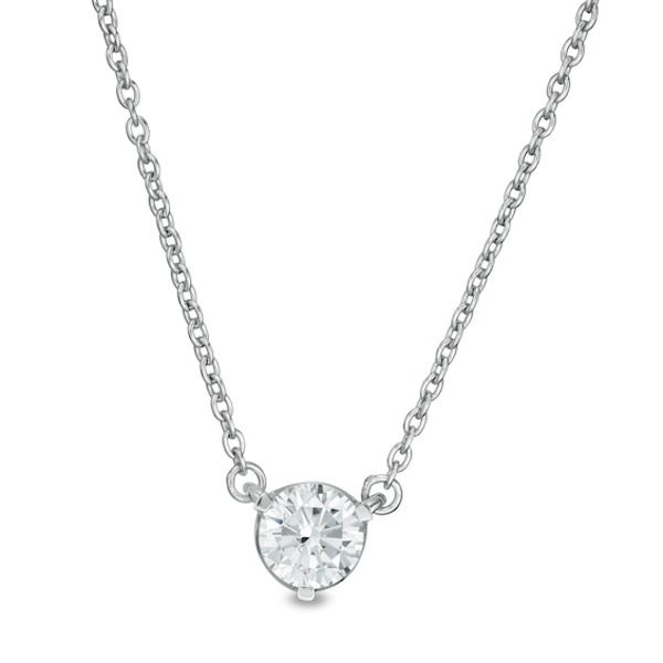 a white diamond necklace on a chain with a small round stone in the center,