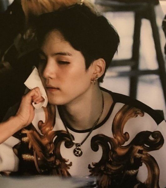 a woman talking on a cell phone while sitting at a table