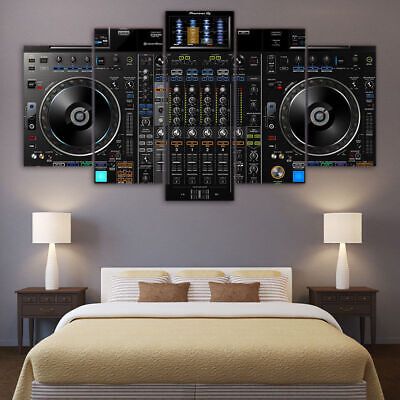 a bed room with a neatly made bed and some dj equipment on the wall above it