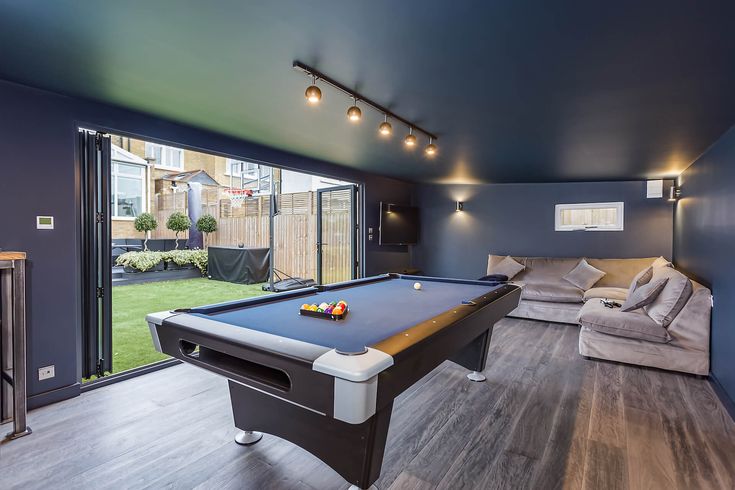 a pool table and couch in a room