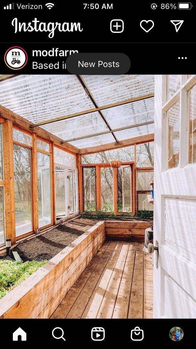 an instagram photo of a greenhouse with plants in the ground and windows on each side