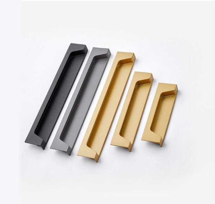 three different types of door handles on a white surface, one black and one gold