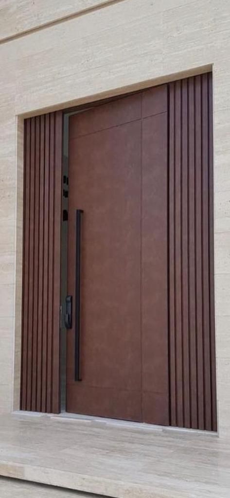 a large brown door sitting on the side of a building