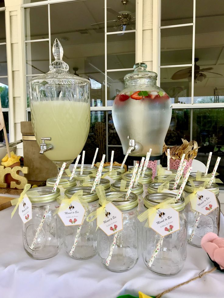 there are many mason jars with strawberries in them on the table next to each other