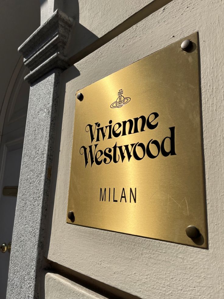 a sign on the side of a building that says wine westwood in black and gold