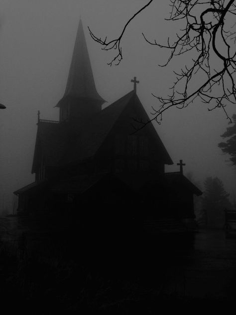 a black and white photo of a church on a foggy day