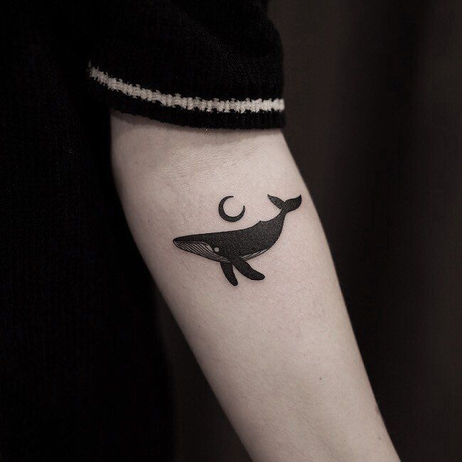 a black and white photo of a whale on the arm