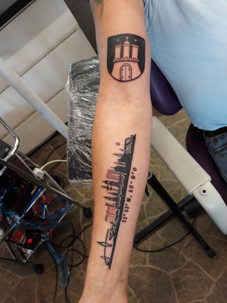 a person with a tattoo on their arm that has a ship in the middle of it