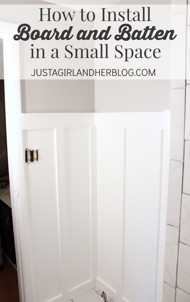 the corner of a bathroom with an open shower door and small space in front of it