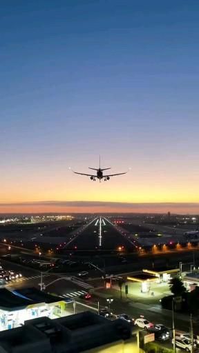 an airplane is flying over the city at night