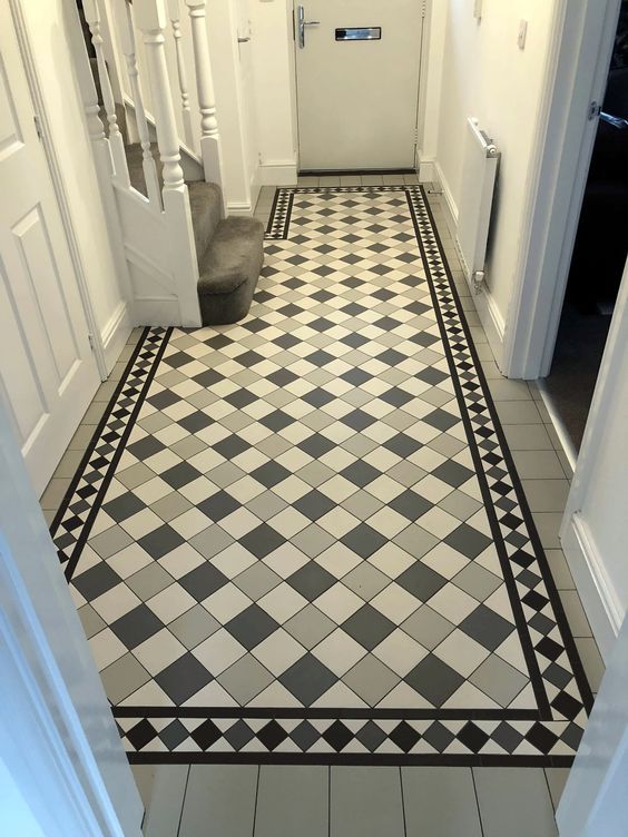 a hallway with black and white checkered flooring