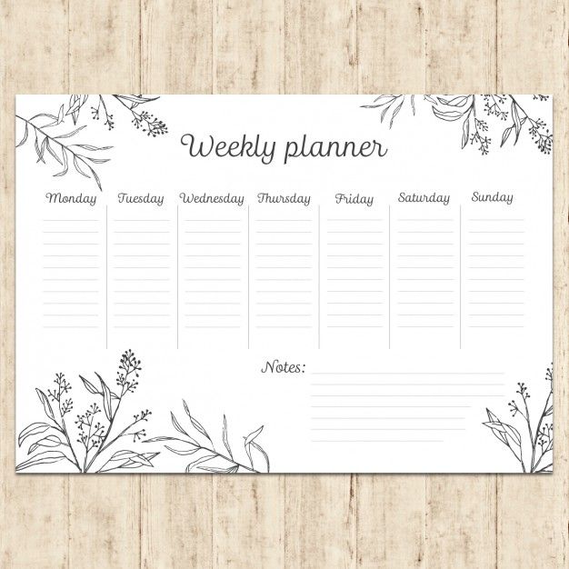 the weekly planner is shown on a wooden surface with flowers and leaves in black ink