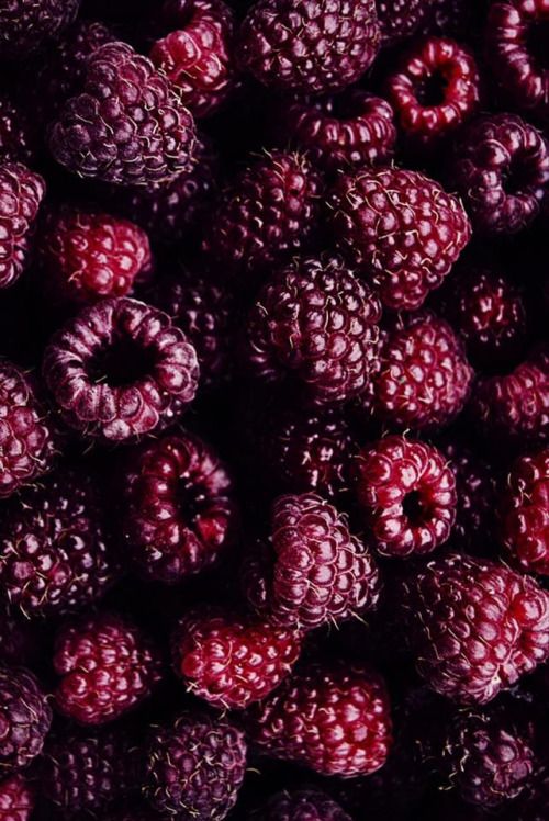 some raspberries that are purple and red