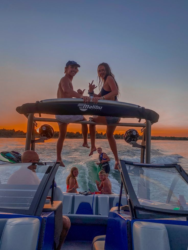 two people sitting on the back of a boat