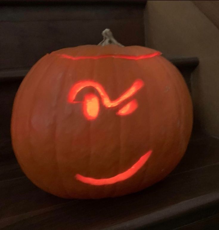 a carved pumpkin with an evil face on it