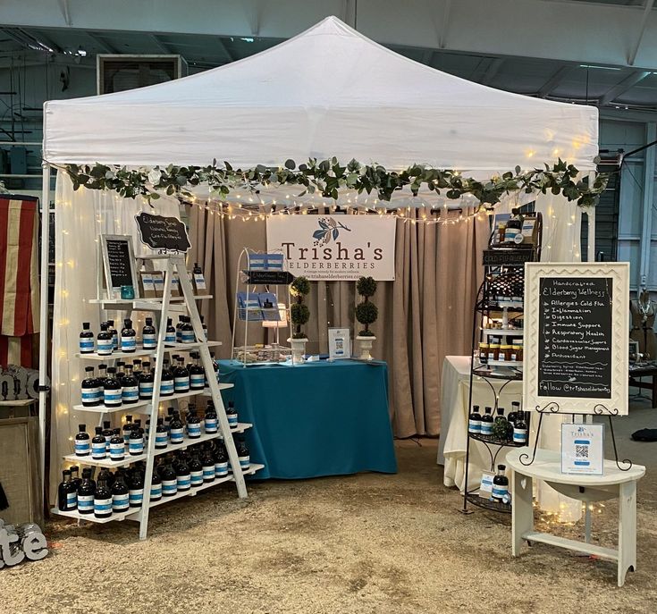 a tent set up with wine bottles on display