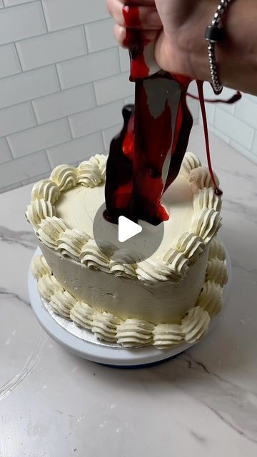 someone is cutting into a cake with a knife