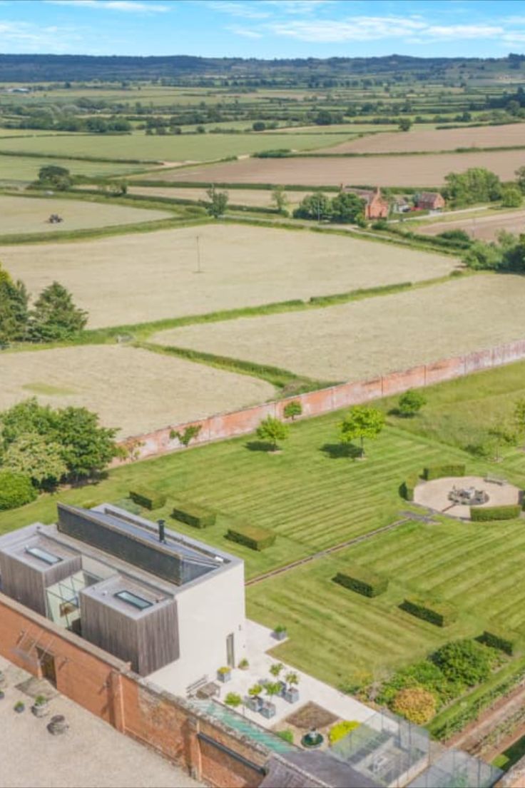 an aerial view of a farm with fields and houses