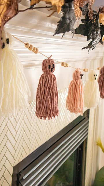 some tassels are hanging from a fireplace mantel