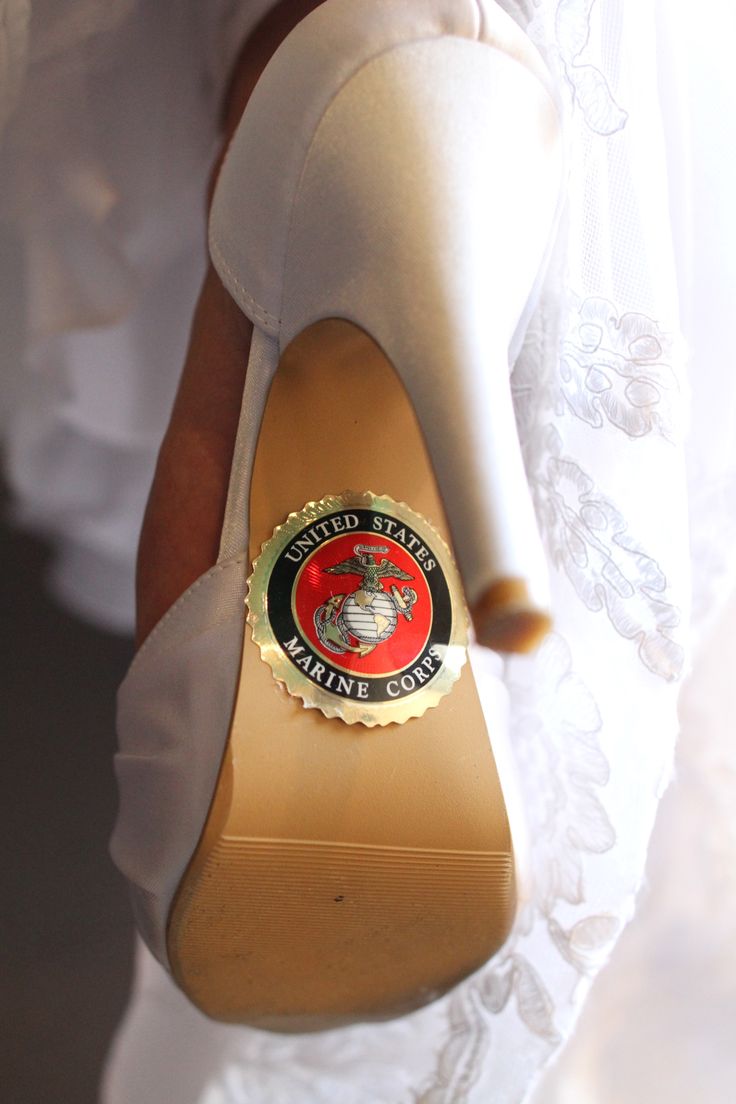 a close up of a person wearing high heels with a bottle cap on their shoe