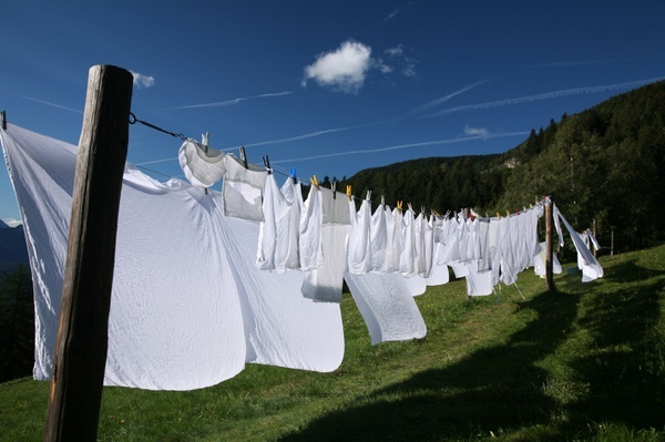 clothes hanging out to dry on a line with mountains in the backgroung