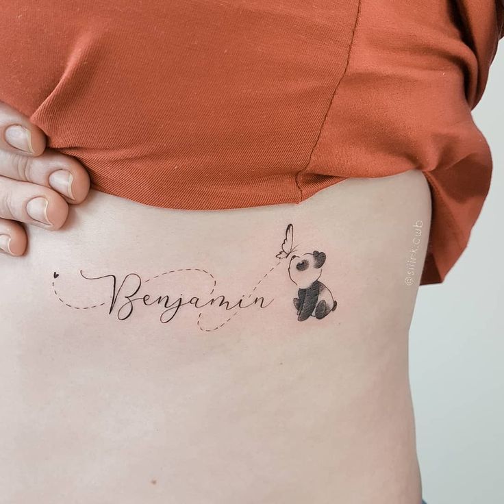 a woman with a small tattoo on her stomach that reads,'bonyann '