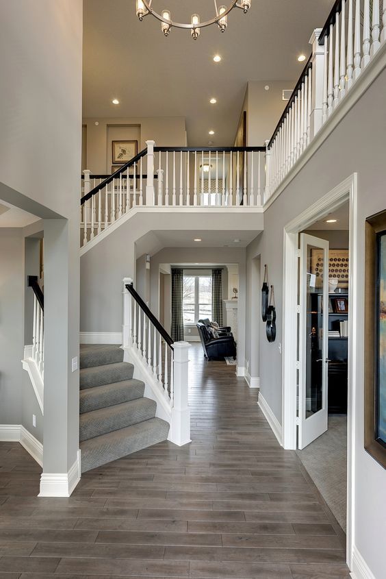 a large open floor plan with stairs leading up to the second story