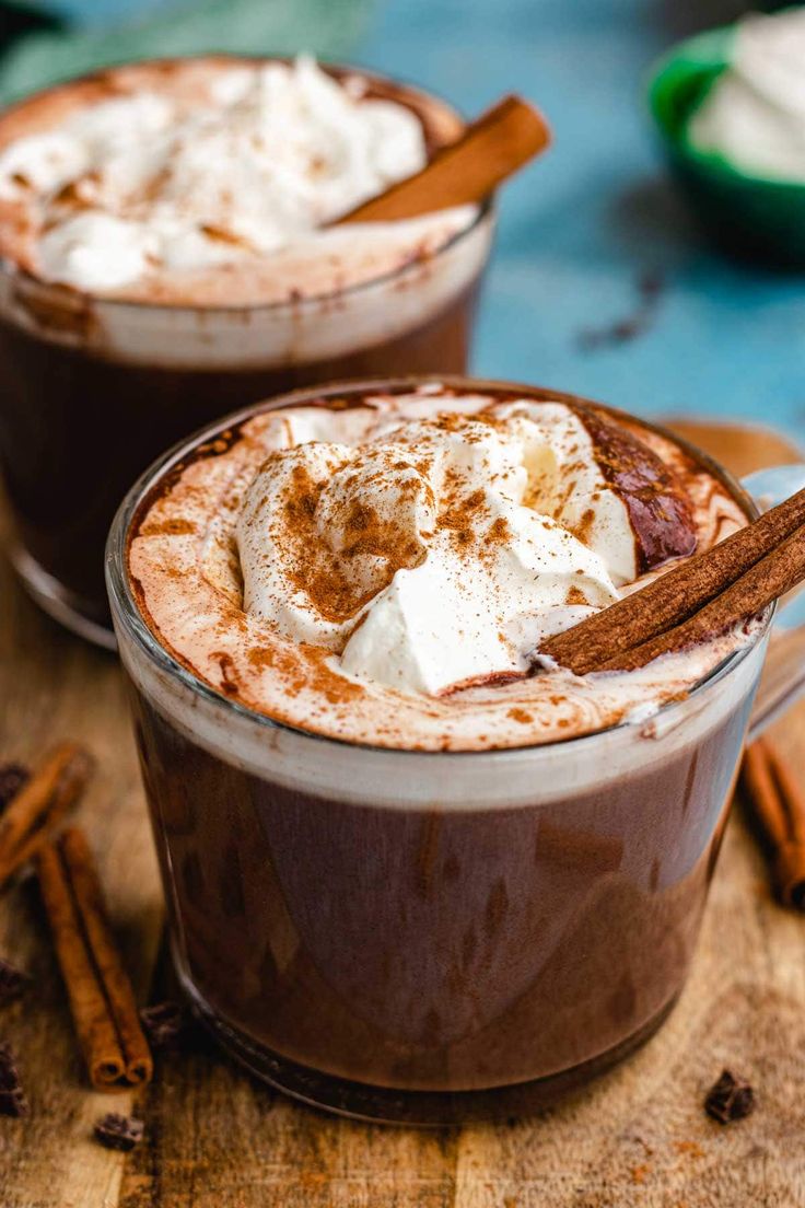 two glasses filled with hot chocolate and whipped cream