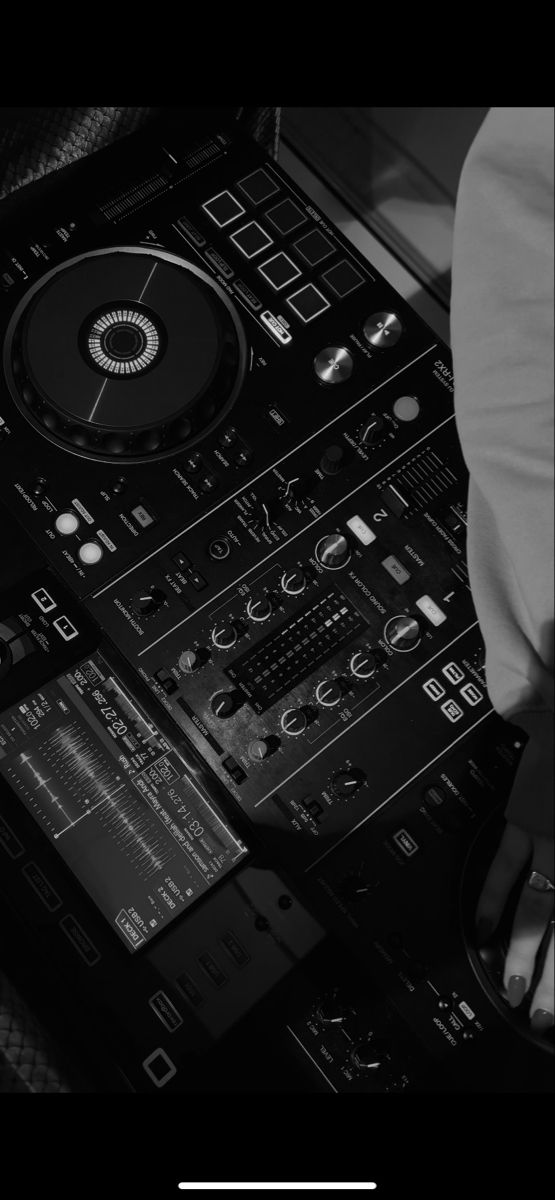 a dj mixing music in front of his mixer