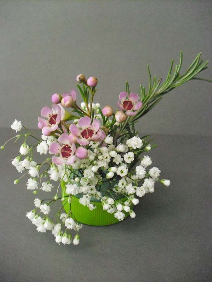 pink and white flowers in a green vase