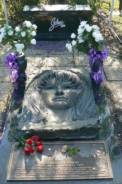 a grave with flowers on it and a headstone