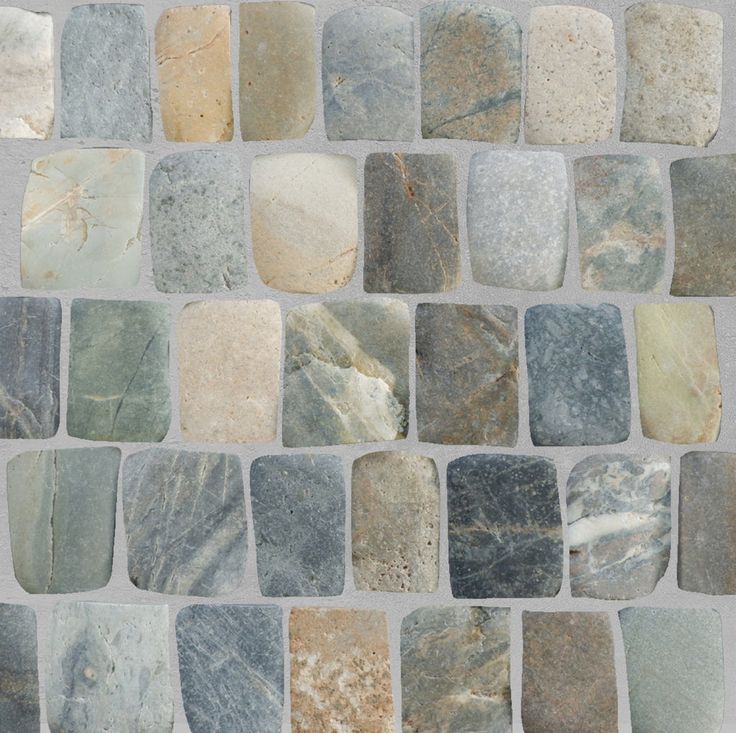 a wall made up of different types of rocks and marbles, all in various colors