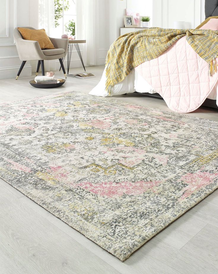 a bedroom with a large rug on the floor