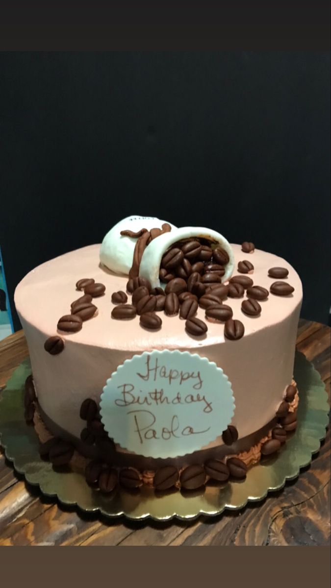 a birthday cake decorated with coffee beans and marshmallows