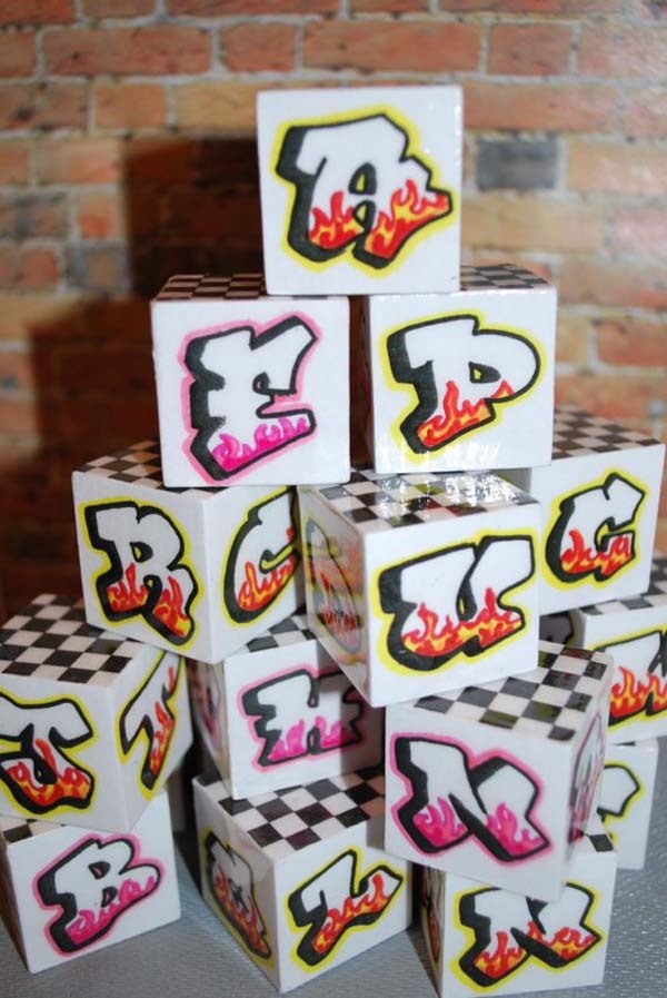 a stack of white boxes sitting on top of each other in front of a brick wall