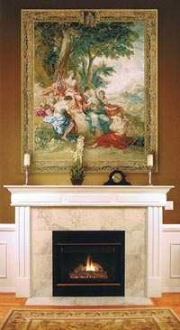 a fireplace in a living room with a painting on it's wall above the fire place