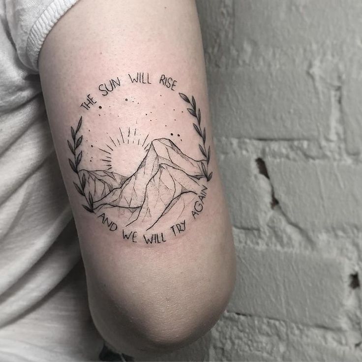 a woman with a tattoo on her arm that says, we sun will rise and we will try