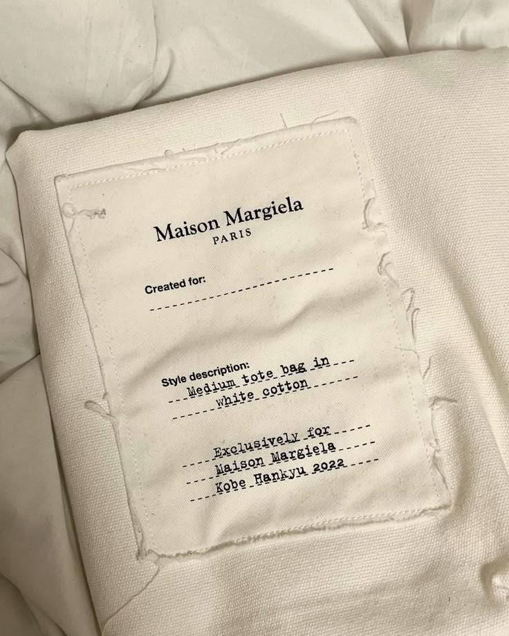 the label on an unmade white bed sheet that has been made into a pillow