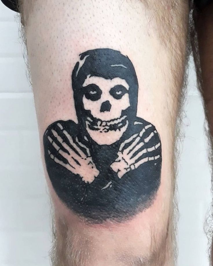 a man with a skeleton tattoo on his leg