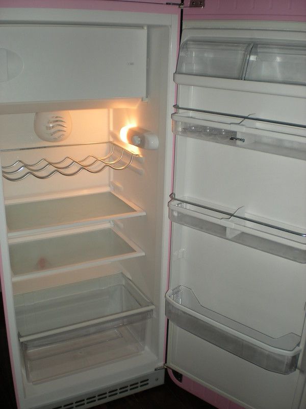 an open refrigerator with the door ajar and no ice maker on it's side